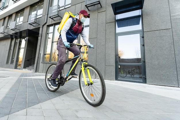 Young delivery man with yellow backpack takeaway concept.