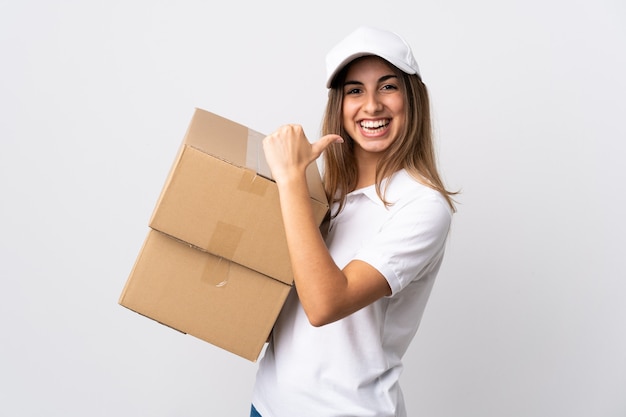 Young delivery woman over isolated white wall proud and self-satisfied