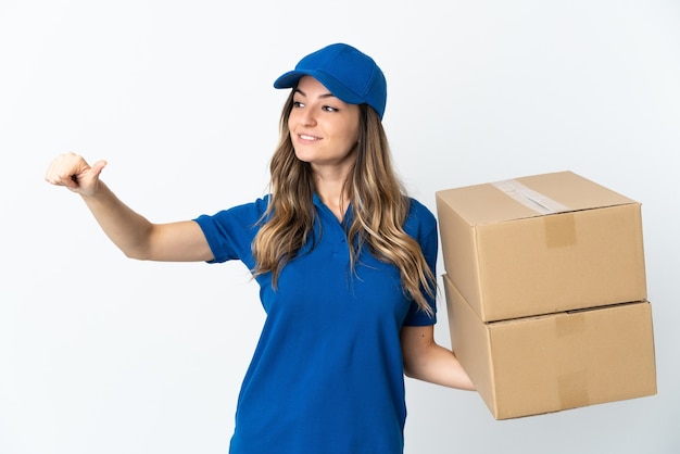 Young delivery woman posing isolated against the blank wall