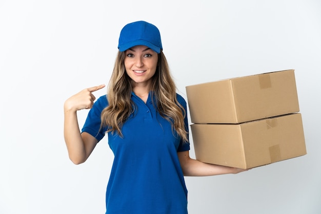 Young delivery woman posing isolated against the blank wall