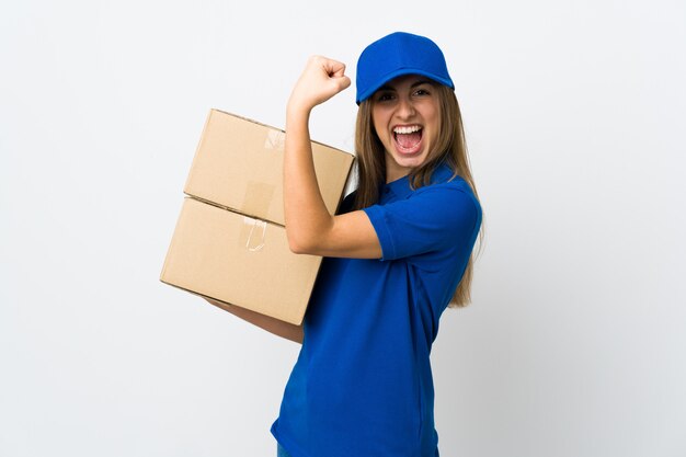 Young delivery woman over white wall doing strong gesture