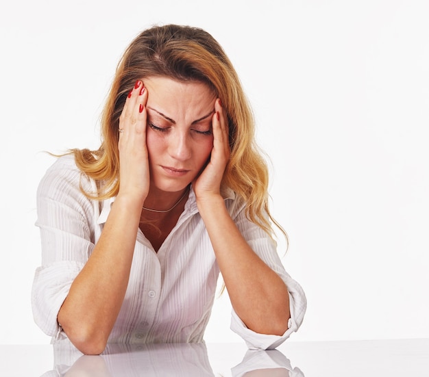 A young depressed or tired woman in office