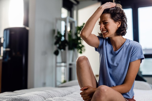 Young desperate woman crying in the bedroom