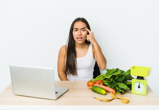 Young dietician asian woman showing a disappointment gesture with forefinger.