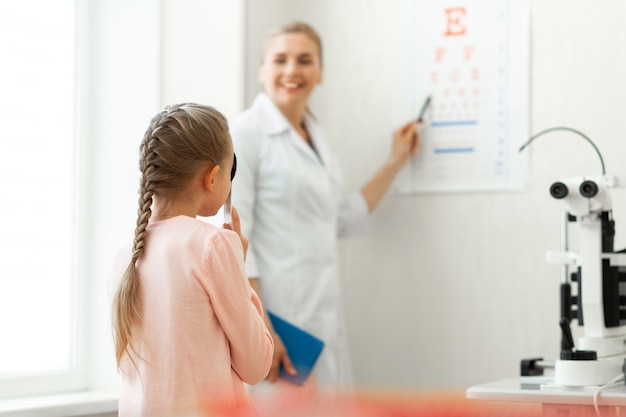 Young diligent patient closing one eye with special sign