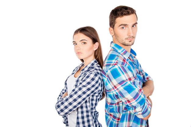 Young disconnected couple standing back to back