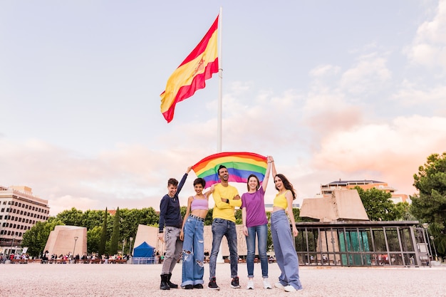 Young diversity multi ethnic lgbtq group  people mixed gender happy with rainbow flag