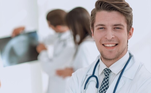 Young doctor on the background of colleaguesphoto with copy space