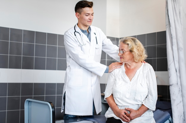 Young doctor consulting elder patient