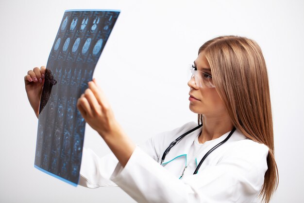 young doctor examines an MRI image of a patient