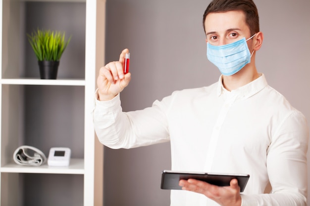 Young doctor holding test tubes with virus tests