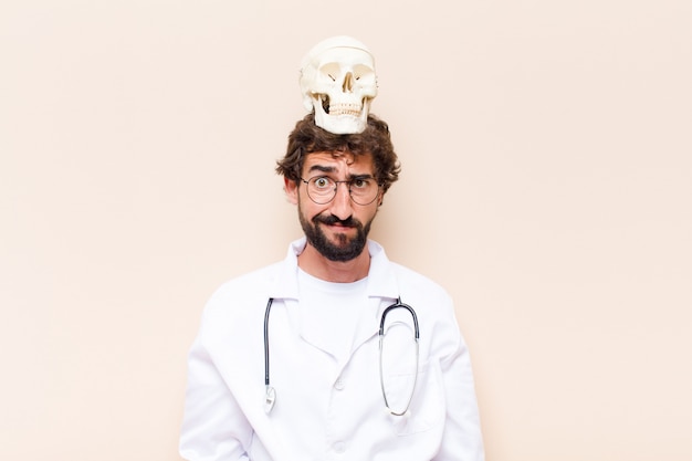 Young doctor and a human skull model