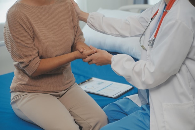 Young doctor is using a stethoscope listen to the heartbeat of the patient Shot of a female doctor giving a male patient a check up