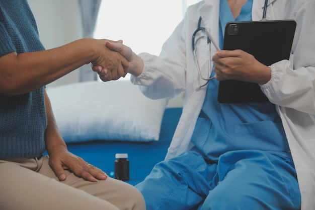 Young doctor is using a stethoscope listen to the heartbeat of the patient Shot of a female doctor giving a male patient a check up