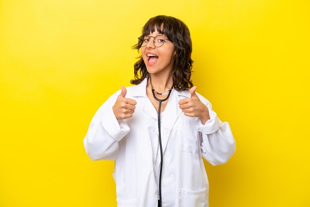 Young doctor latin woman isolated on yellow background