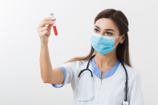 Young doctor looking at a blood sample