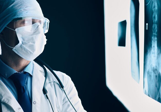 Young doctor looking XRay image on isolated white background