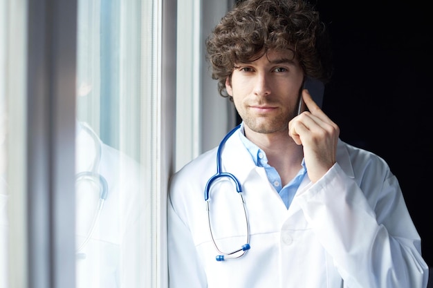 Young doctor making call