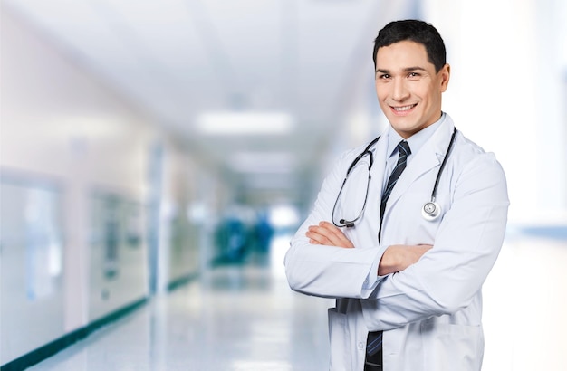 Young doctor man with stethoscope in clinic