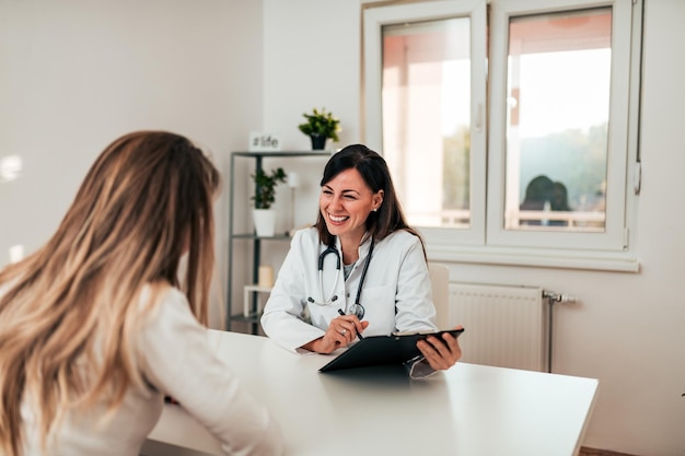 Young doctor and patient talking in the doctoraposs office