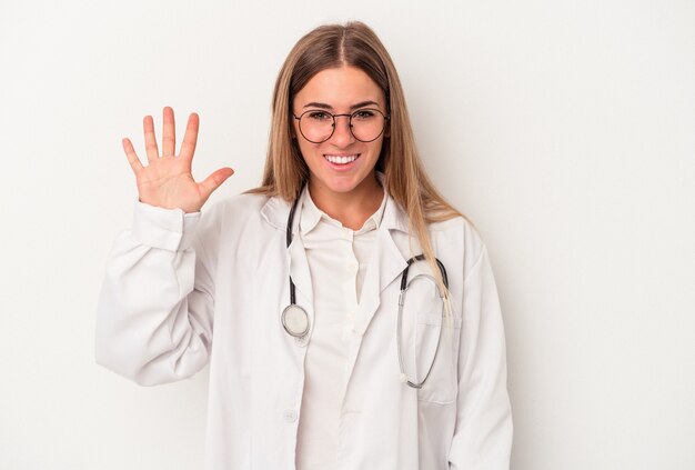 Young doctor Russian woman isolated on white background smiling cheerful showing number five with fingers.