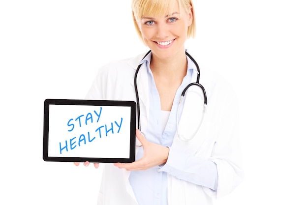 a young doctor standing with tablet over white background
