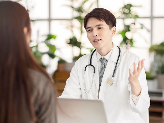 Young doctor talking to patient