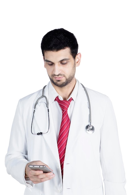 Young doctor typing message on mobile phone