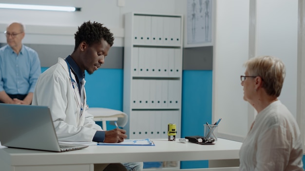 Young doctor using stamp on prescription paper on desk