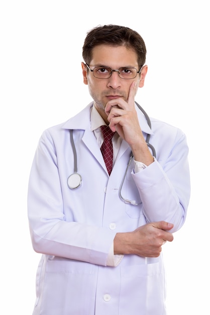 young doctor wearing eyeglasses while thinking