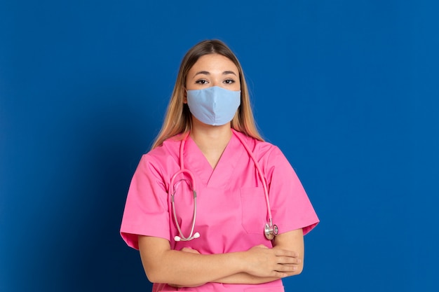 Young doctor wearing a mask face and a pink uniform