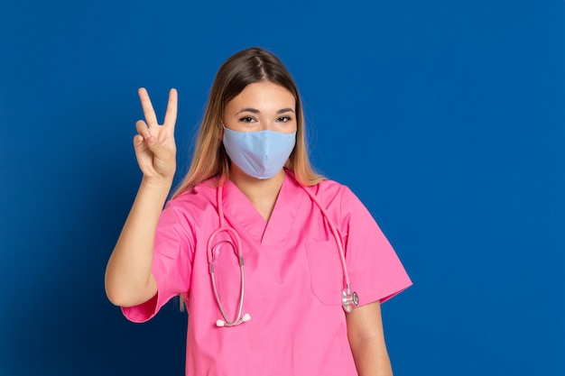 Young doctor wearing a mask face and a pink uniform