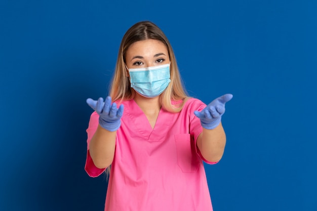 Young doctor wearing a mask face and a pink uniform