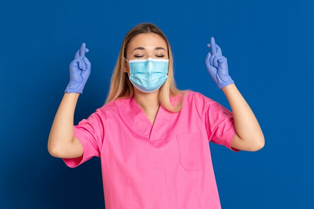 Young doctor wearing a mask face and a pink uniform