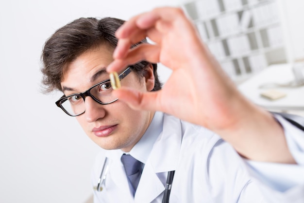 Young doctor with pill