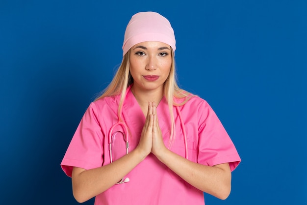 Young doctor with a pink uniform and a scarf