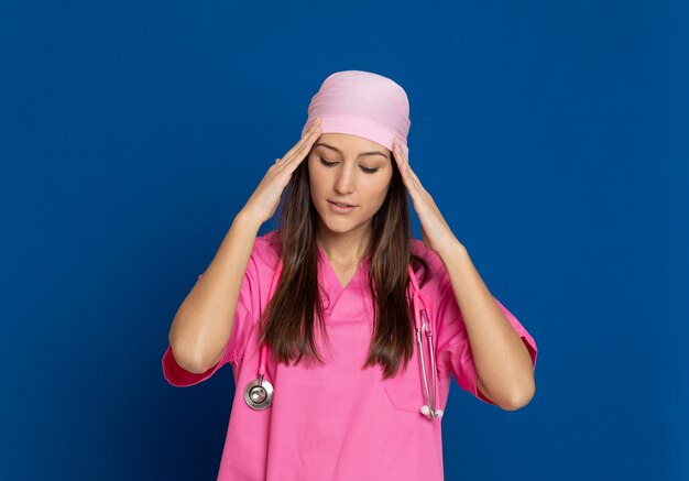 Photo young doctor with a pink uniform