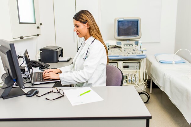 Foto giovane medico con lo stetoscopio nel suo ambulatorio.