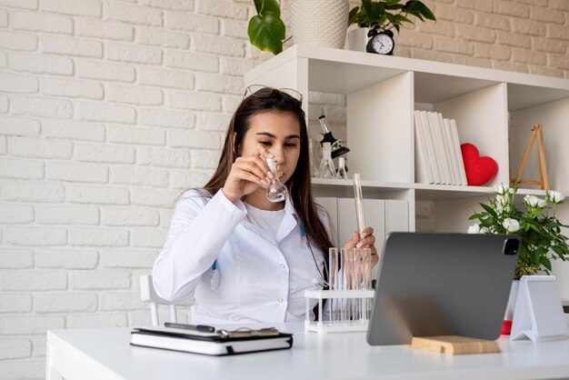 Young doctor woman having online call or consulting doctor working online from home