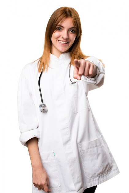 Young doctor woman pointing to the front