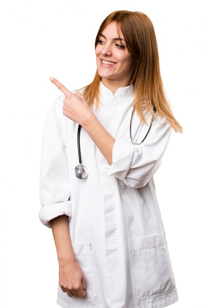 Young doctor woman pointing to the lateral