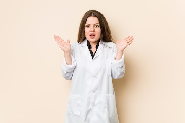 Young doctor woman surprised and shocked.