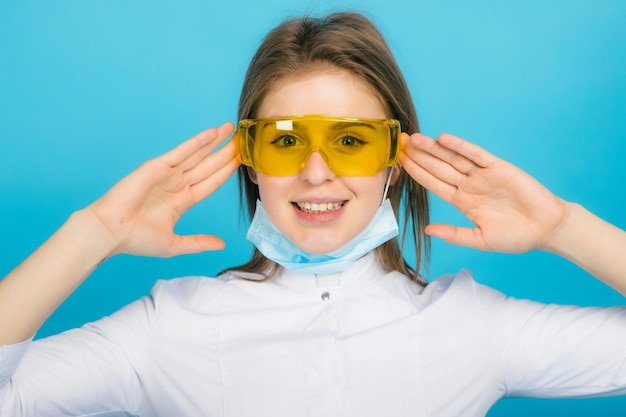 Young doctor woman with syringe and yellow glasses