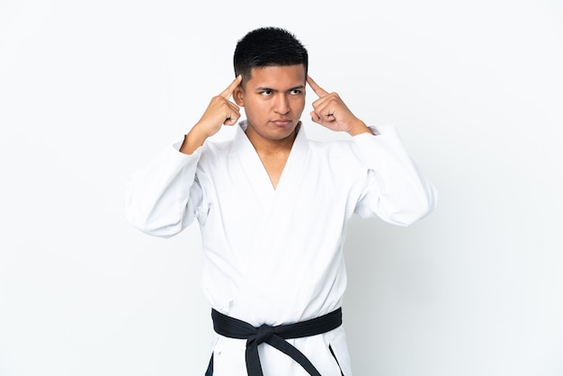 Young Ecuadorian man doing karate isolated