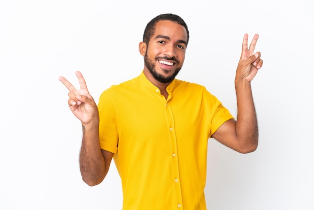 Young Ecuadorian man isolated on white background showing victory sign with both hands