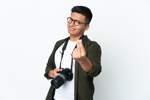 Young Ecuadorian photographer isolated on white wall making money gesture