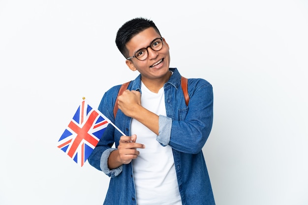 Young Ecuadorian woman holding an United Kingdom flag isolated on white background celebrating a victory