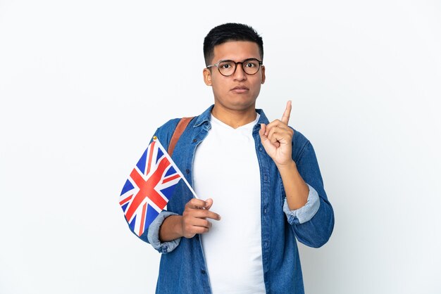 Young Ecuadorian woman holding an United Kingdom flag isolated on white background intending to realizes the solution while lifting a finger up