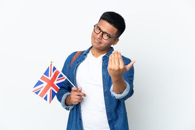 Young Ecuadorian woman holding an United Kingdom flag isolated on white background inviting to come with hand. Happy that you came