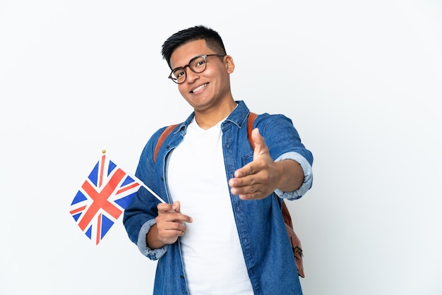 Young Ecuadorian woman holding an United Kingdom flag isolated on white background shaking hands for closing a good deal